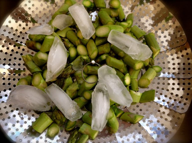 Shocked asparagus in a steamer basket