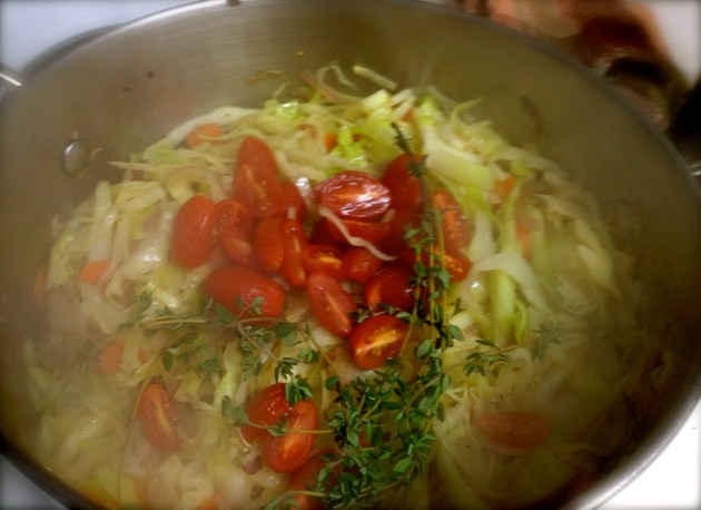 Cabbage has wilted down, adding tomatoes and thyme Cabbage has wilted down, adding tomatoes and thyme