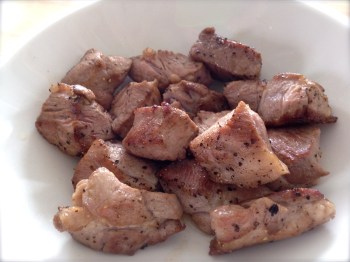 Browned meat pieces are resting in a bowl