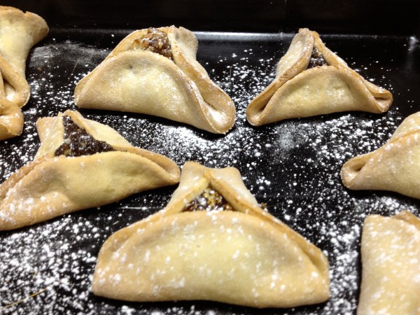 Hamantashen, lightly dusted with powdered sugar Hamantashen, lightly dusted with powdered sugar