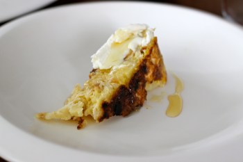 Enjoying a warm slice of Matzoh Brei with cream cheese and honey