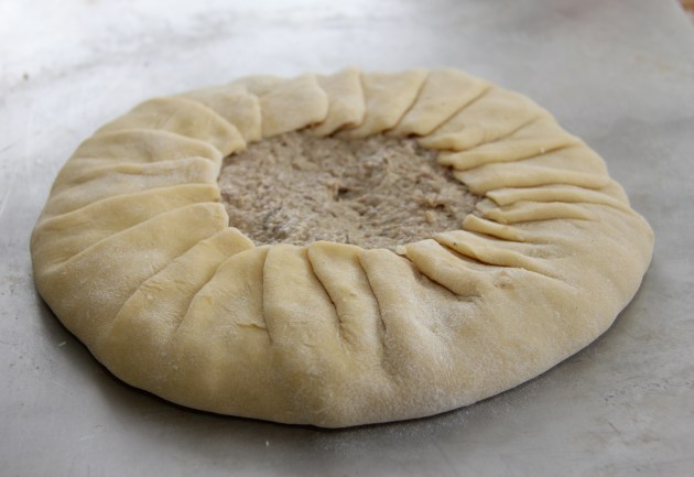 Dough pinch-pleated around the filling