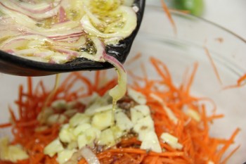 Pouring bubbling oil over the spices
