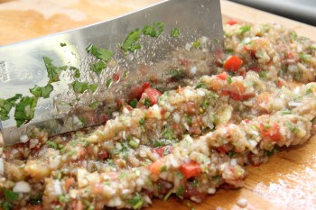 Finely chopped eggplant caviar. Chopping with a cleaver