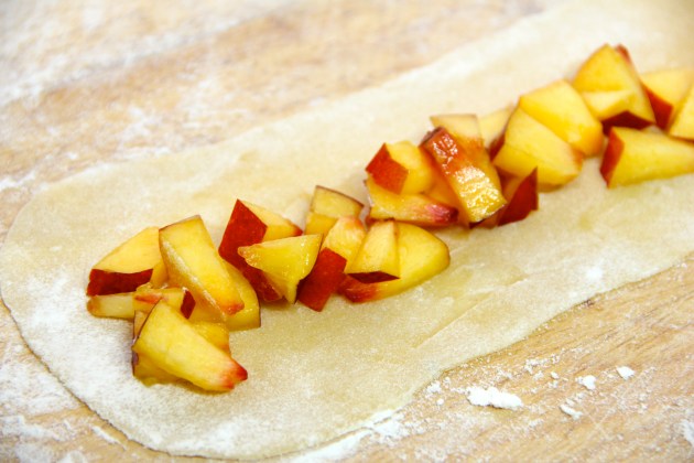 Arranging the chopped nectarines on a strip of dough