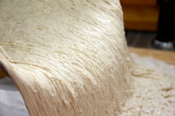 Ciabatta dough is sliding onto a board