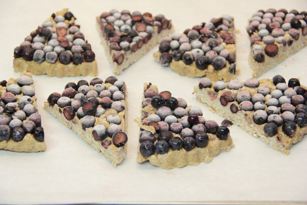 Sliced scones on a parchment, ready to bake