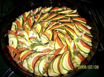 Raw vegetables layered over piperade for Confit Bayldi
