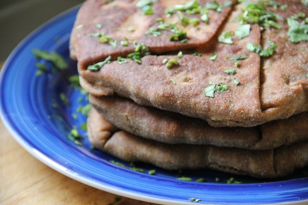 Freshly made plăcintă pies stacked on a plate